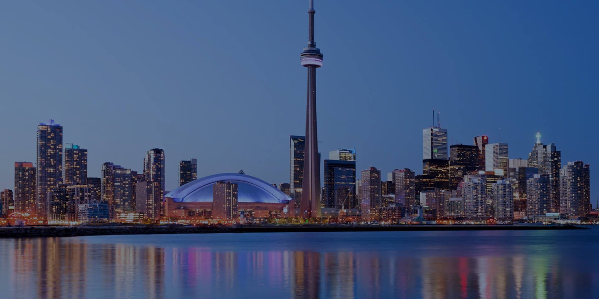 Toronto skyline at dusk — host city of IEEE EMBC 2026